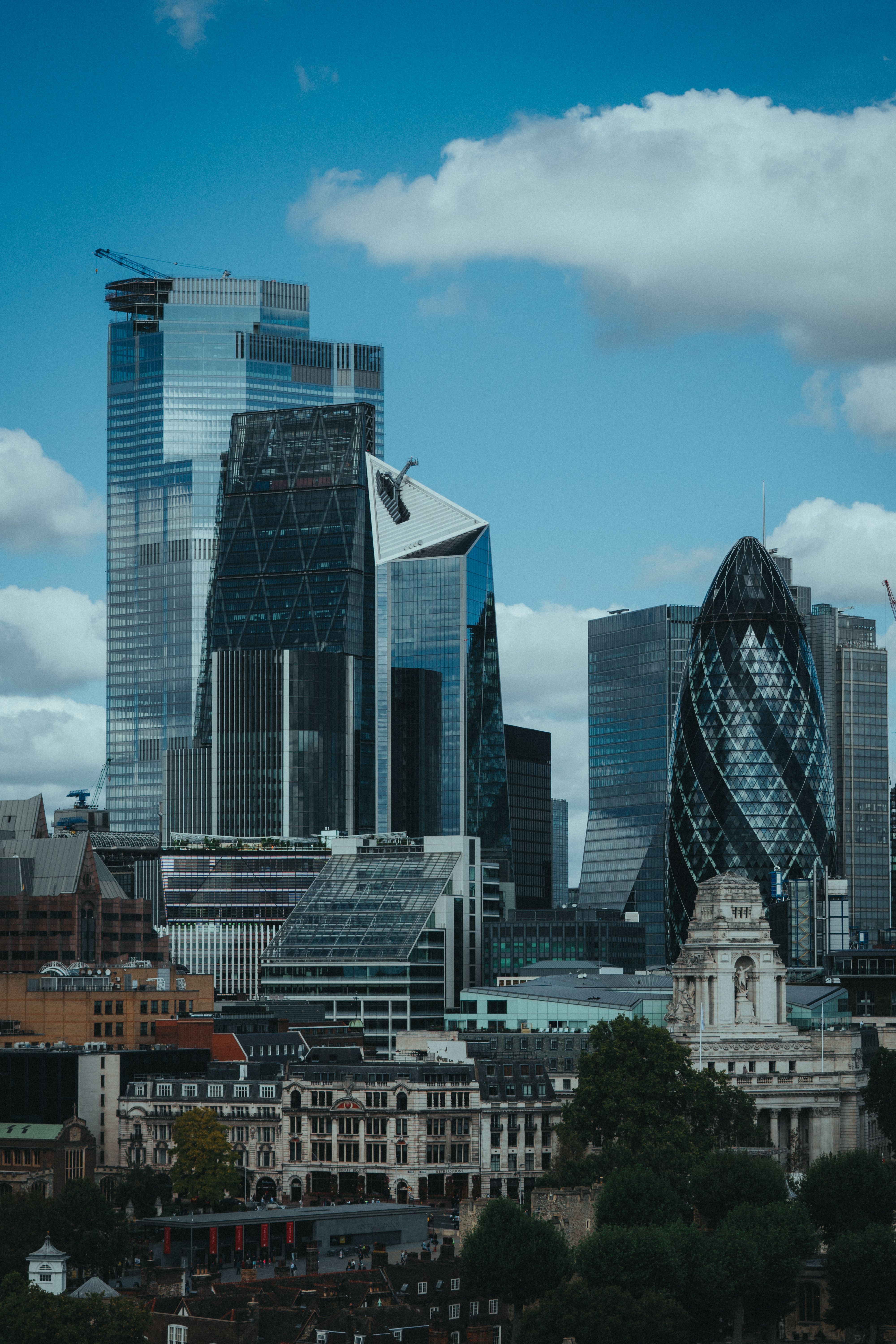 Skyscrapers of the City of London, including the Gherkin, under a blue sky